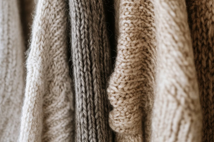 Cozy Knitted Sweaters in Neutral Tones on Hangers