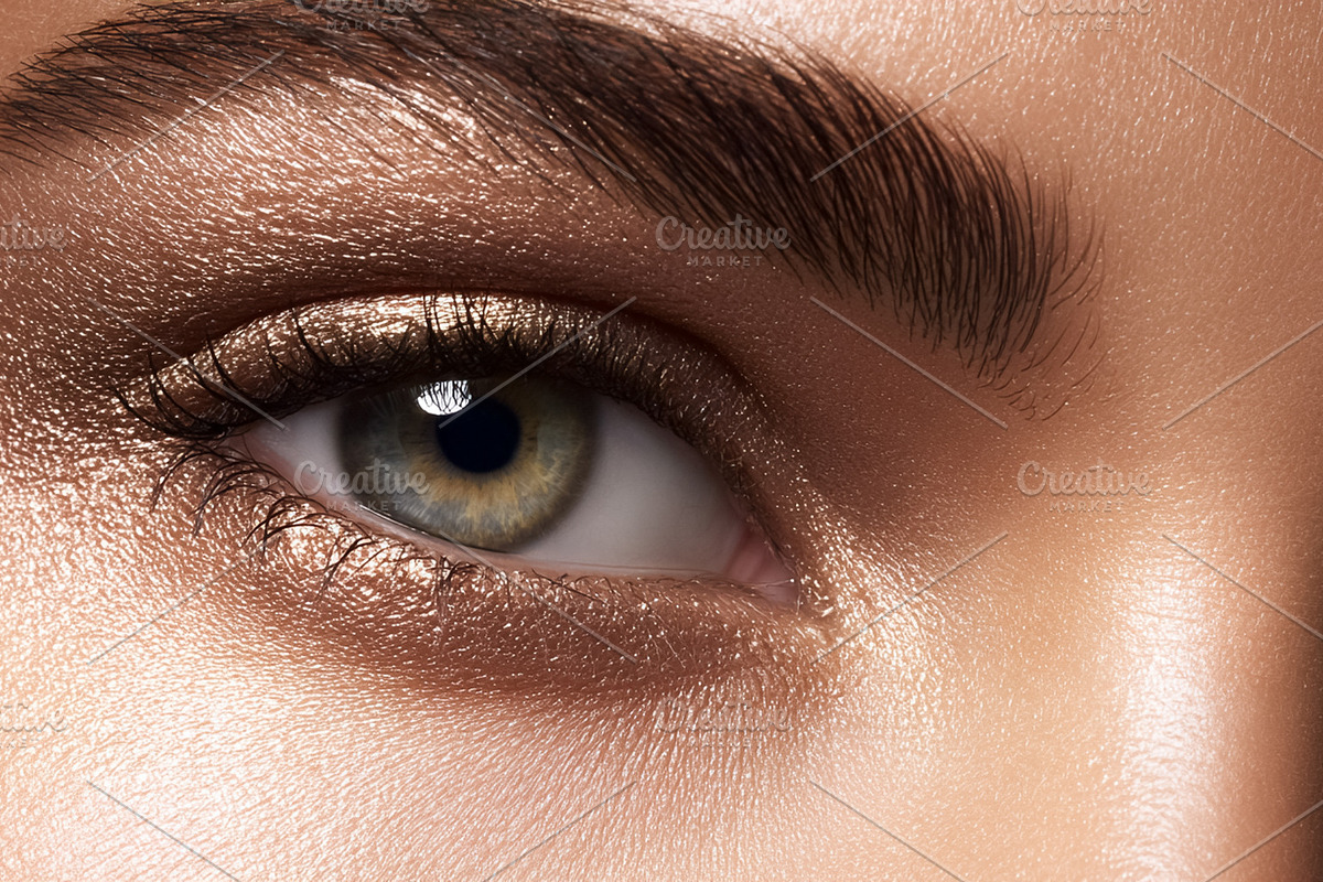 Female eye with shimmer bronze eyeshadow and bold groomed eyebro, a Beauty & Fashion Photo by Studio ANNA (Photo 2 of 2)