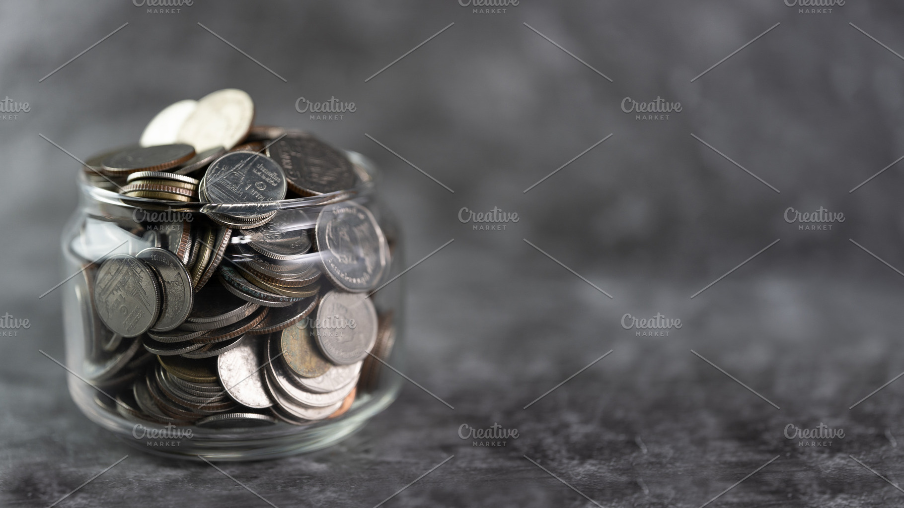 Coins in a glass jar Savings and inv, a Business Photo by Guitarfoto Studio