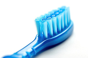 New toothbrush on white background, a Health & Medical Photo by AlyaAnd