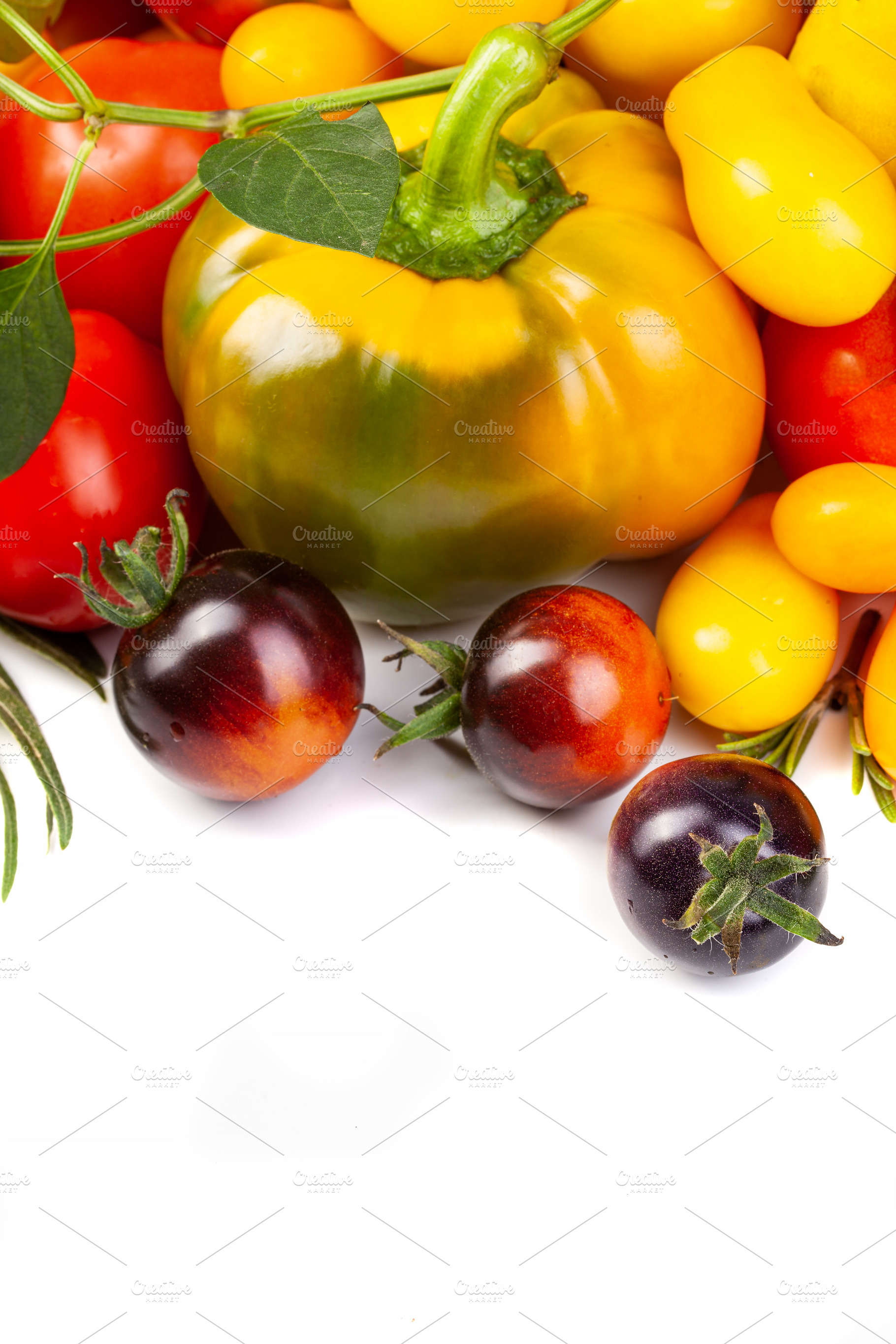 Assorted tomatoes and vegetables isolated on white background. P, a Nature Photo by eleana