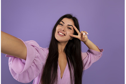 Joyful armenian woman taking selfie, a Person Photo by Prostock-Studio
