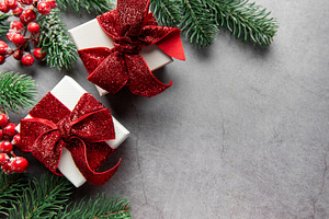 Christmas gifts with red glitter bows on grey background, a Holiday Photo by Olena Rudo