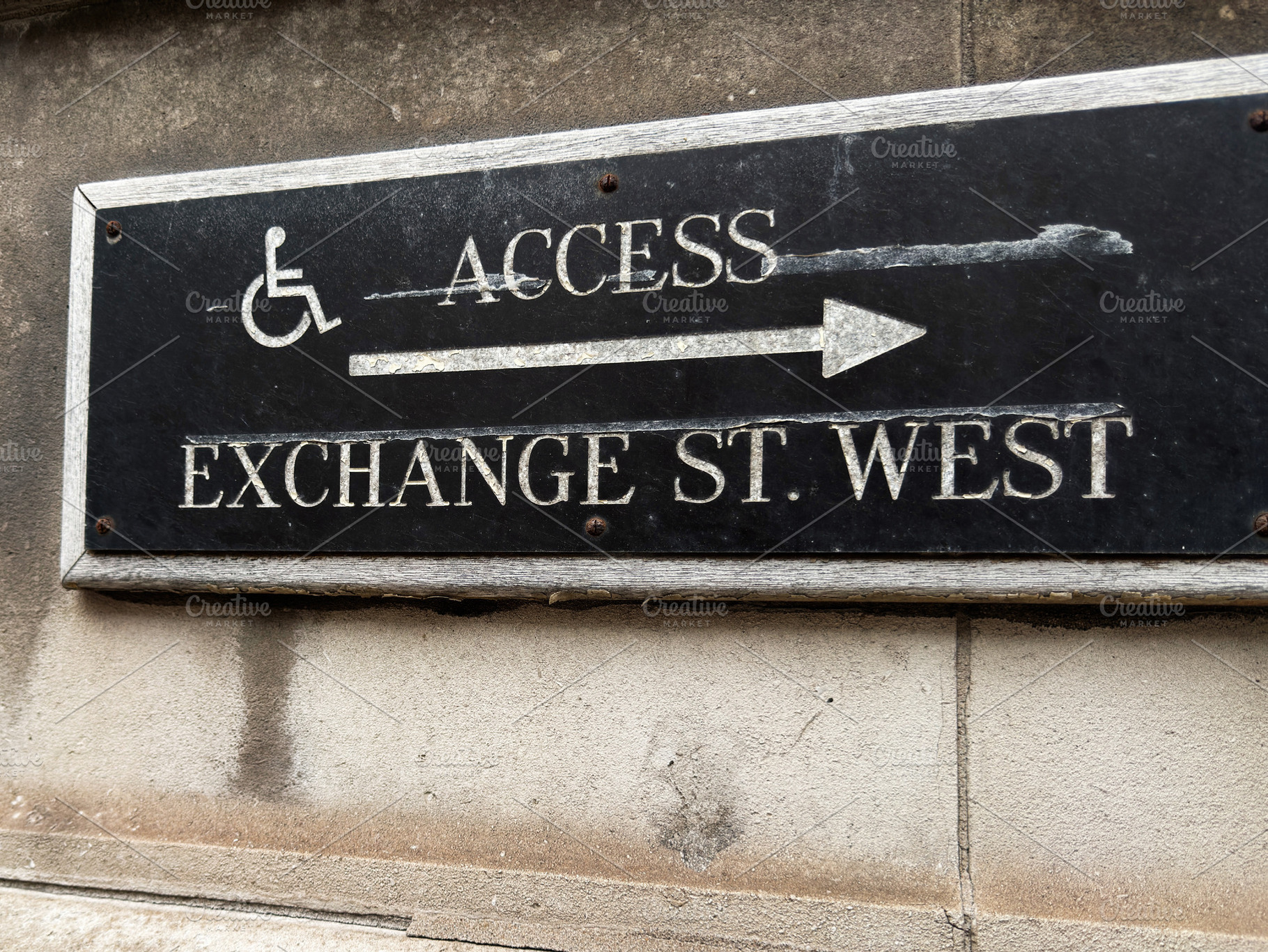 Black accessibility sign for Exchange St West with wheelchair ar, a Photo by AS photostudio