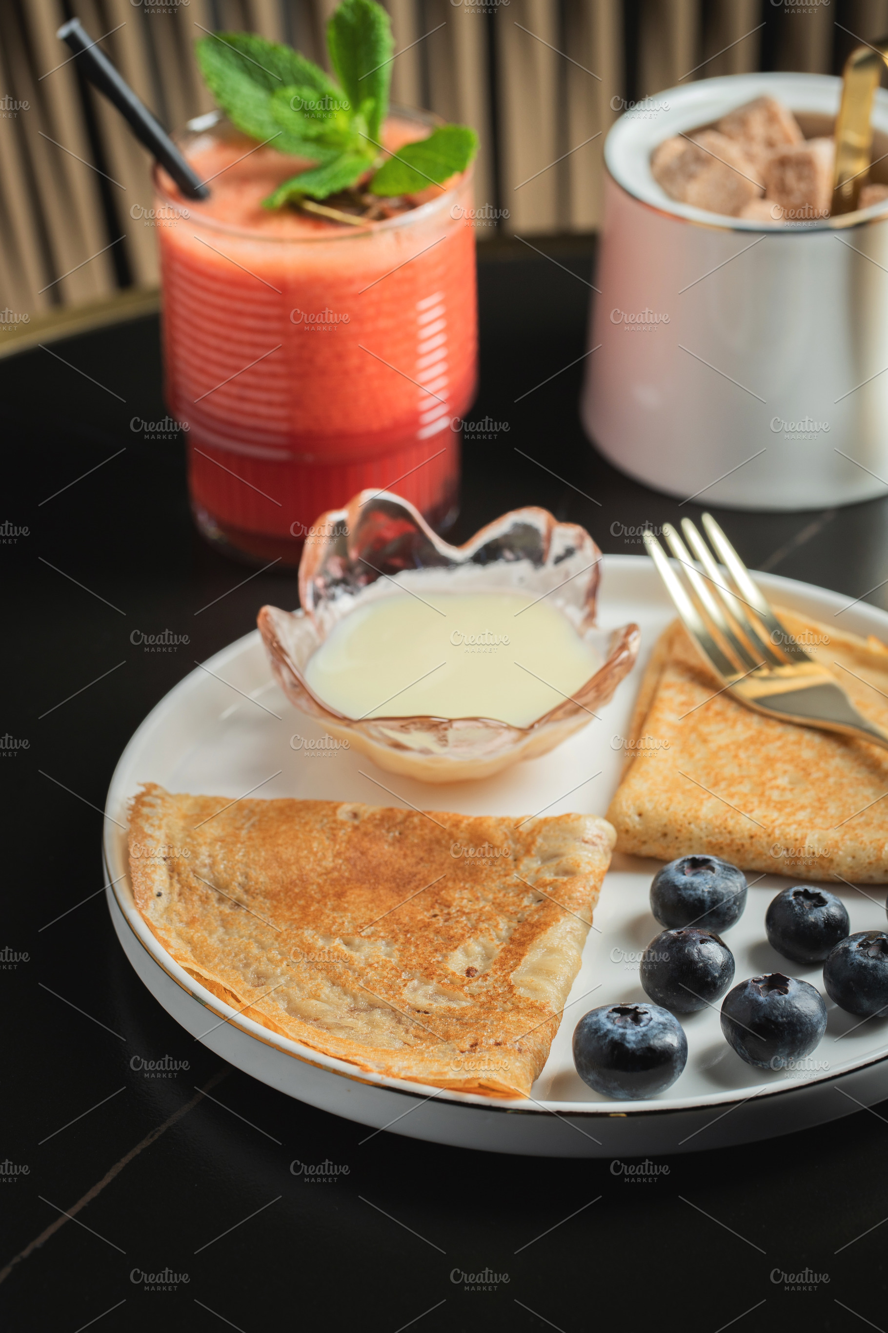 Pancakes with blueberry and honey on a white plate, a Food & Drink Photo by Budarinphoto
