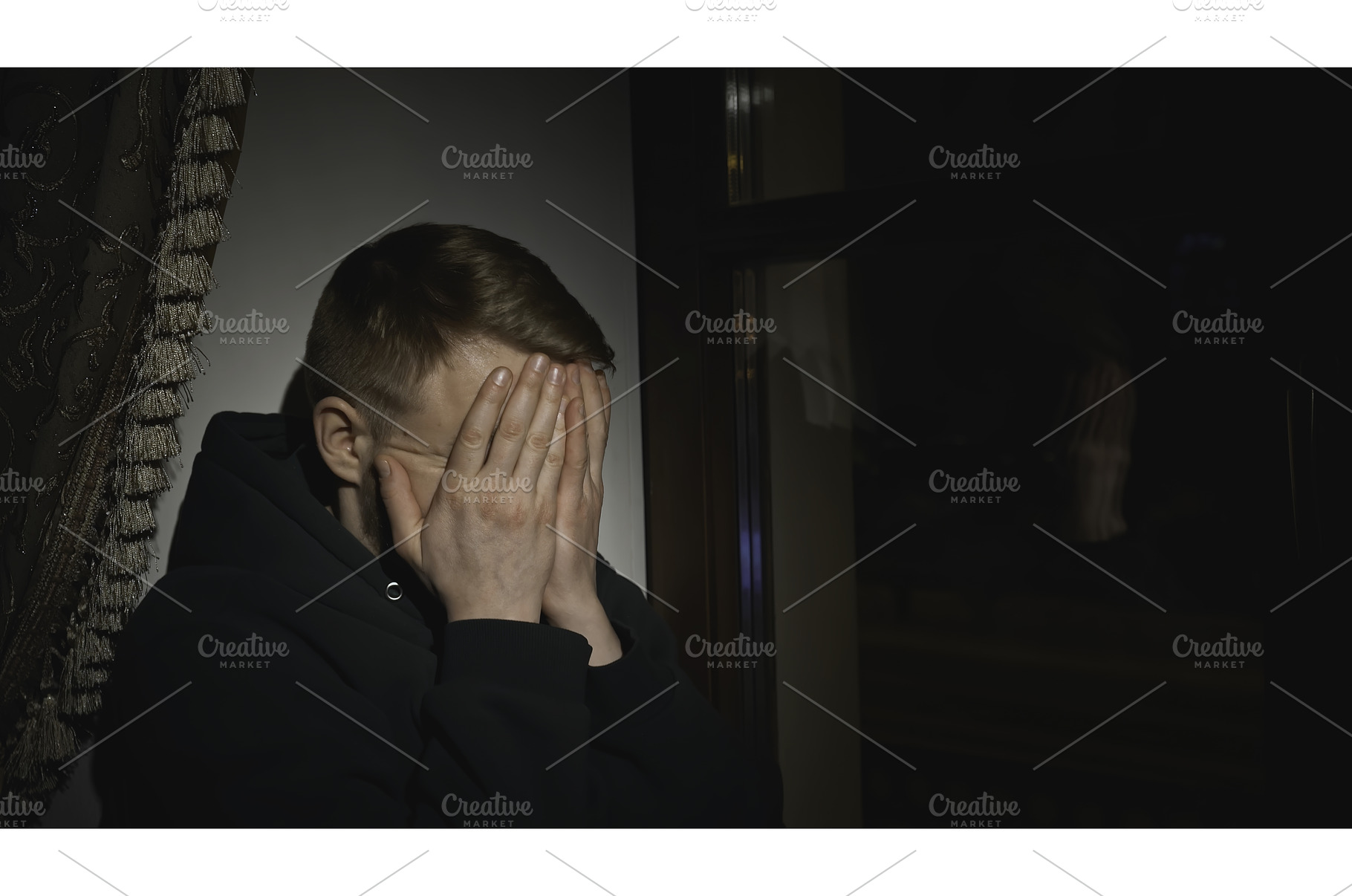 Young man sits tired and looks out, a Person Photo by Media Whale Stock