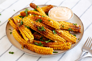 Homemade Spicy Corn Ribs with Mayo on a Plate, side view., a Food & Drink Photo by LiudmylaChuhunova