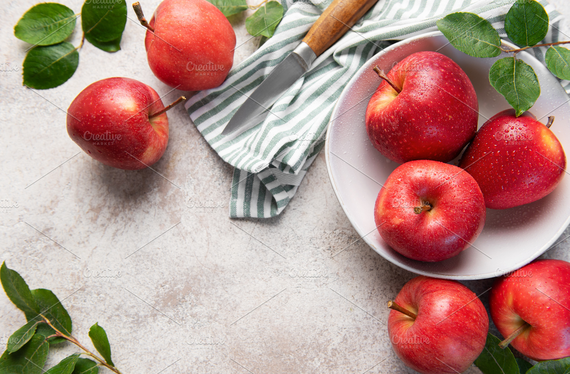 Fresh red apples with water drops in bowl on kitchen table, a Food & Drink Photo by Olena Rudo