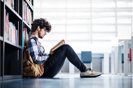 Male student in library, looking for, a School & Education Photo by HalfPoint