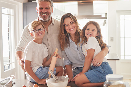 Kitchen, cooking and family in portrait with breakfast food together and smile for support, love and care. Happy parents or father and mother teaching children or kids to cook or bake for development, a Photo by Peopleimages.com