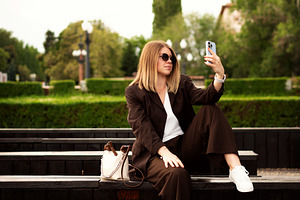 Young woman sitting outdoors, a Person Photo by Elena Vagengeim