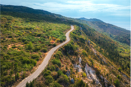 Aerial view of winding mountain road, a Nature Photo by den-belitsky