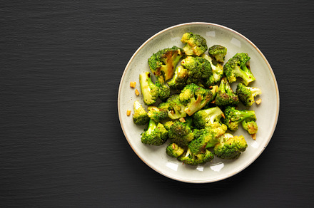 Homemade Pan-Fried Broccoli on a Plate on a black background, to, a Food & Drink Photo by LiudmylaChuhunova