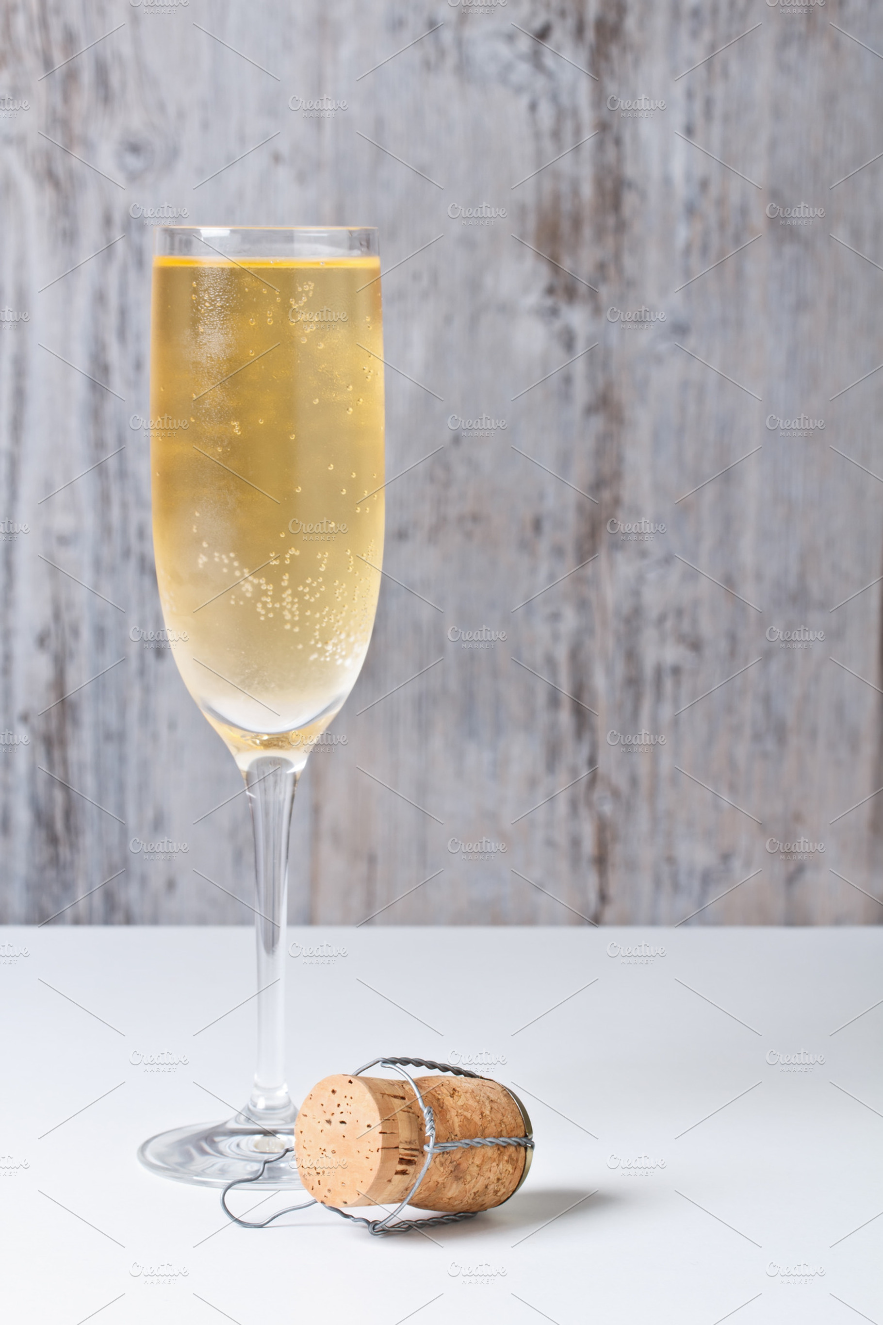 Champagne glass and cork stock photo containing alcohol and beverage