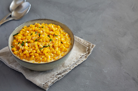 Homemade Slow Cooker Creamed Corn in a Bowl on a gray background, a Food & Drink Photo by LiudmylaChuhunova