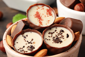 Concept of sweets with chocolate candies on wooden background, a Food & Drink Photo by AtlasStudio PRO