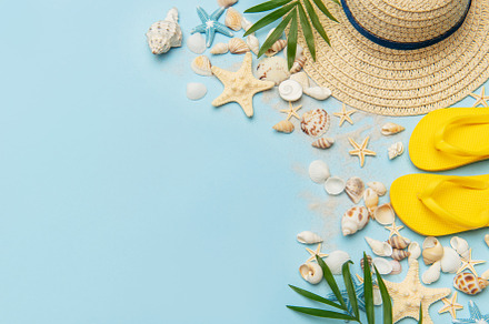 Beach accessories creating summer holiday mood on blue backgroun