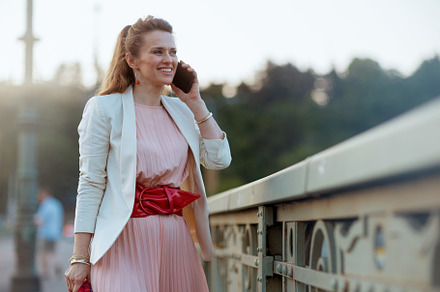 smiling elegant 40 years old woman in city talking on phone, a Person Photo by Alliance Images