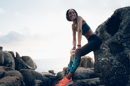Smiling woman resting outdoors, a Sports & Recreation Photo by Jacob Lund