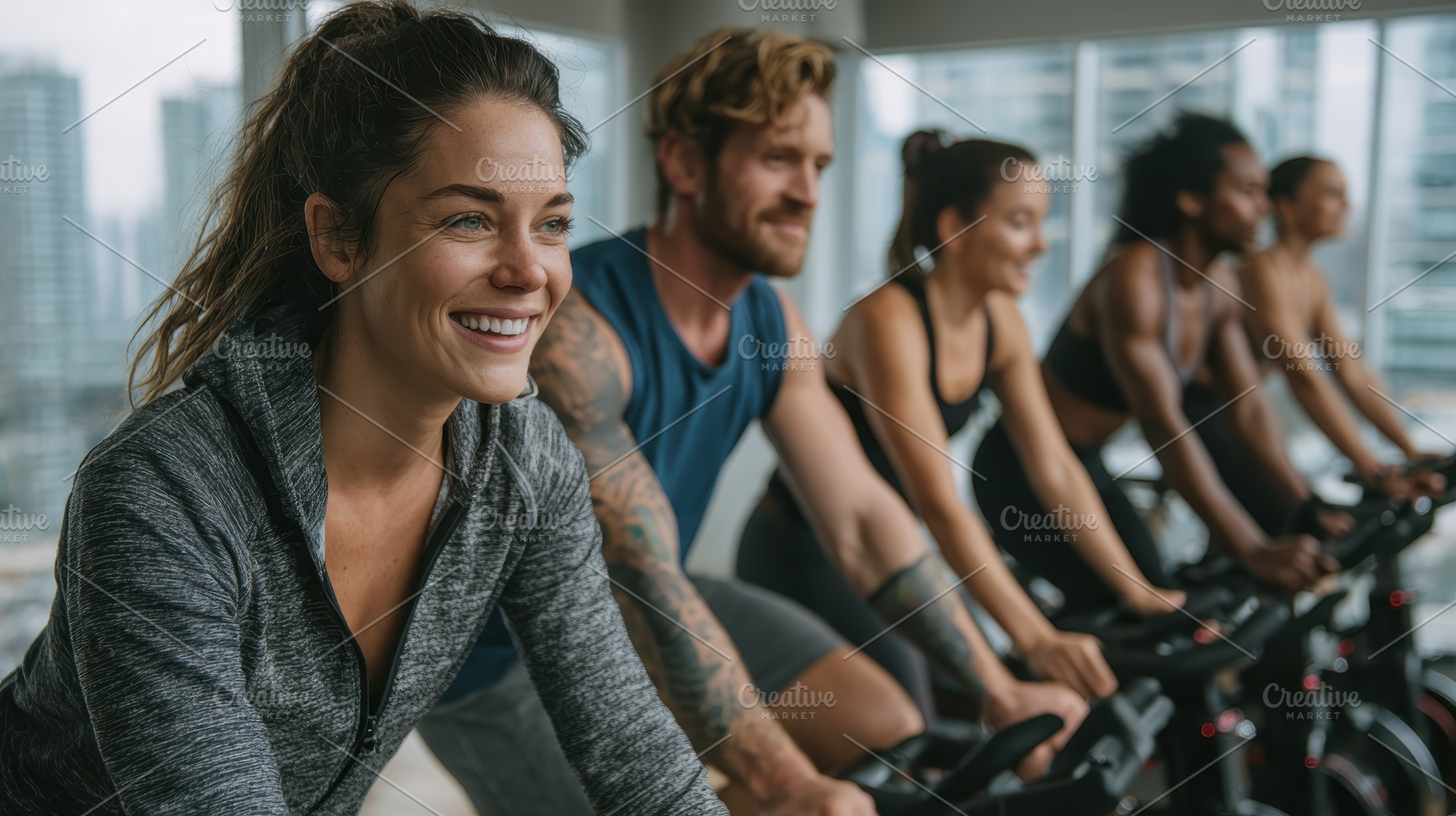 Happy woman in spin class fitness wo, a Photo by Pixeness Studio