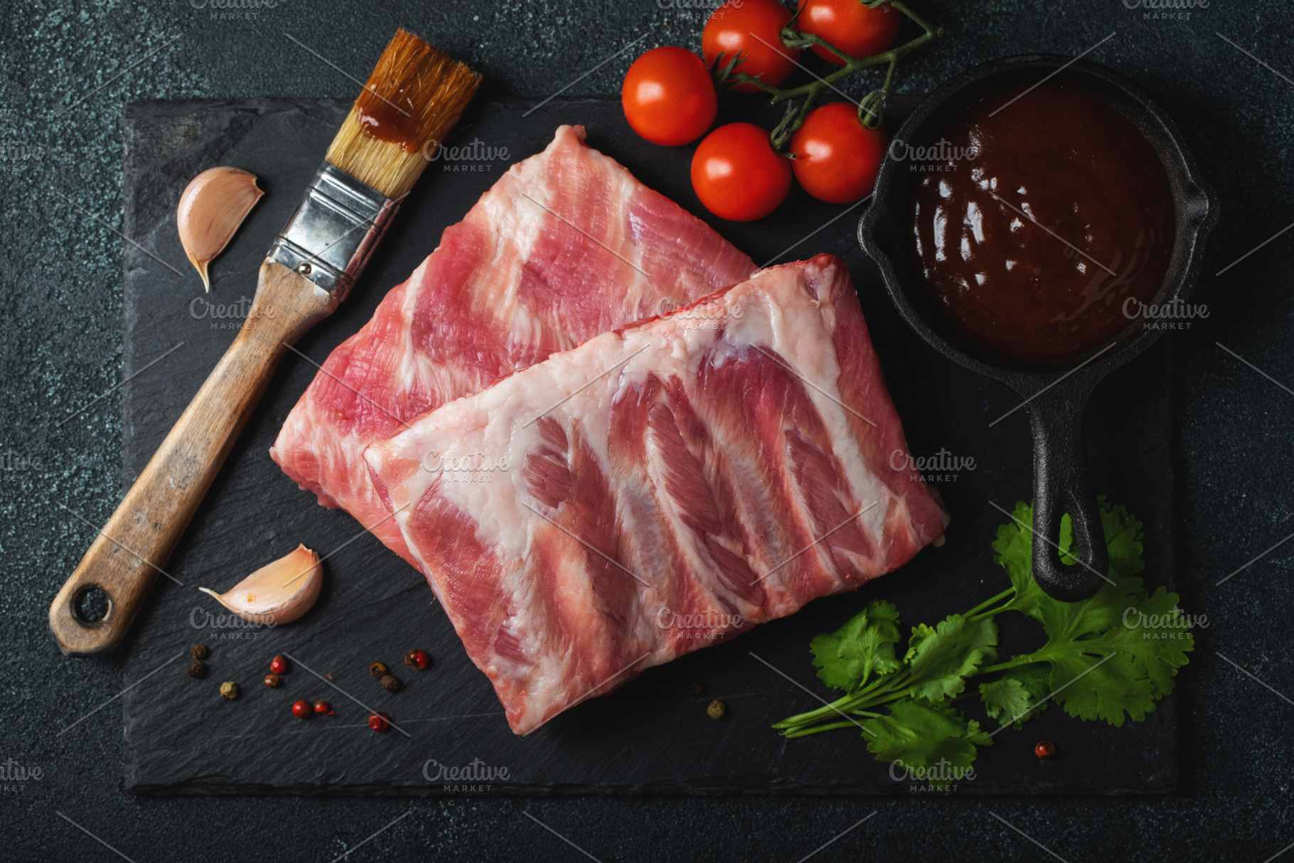 Raw meat. Raw pork ribs from the back with meat on a black background. backgrou, a Food & Drink Photo by Budarinphoto