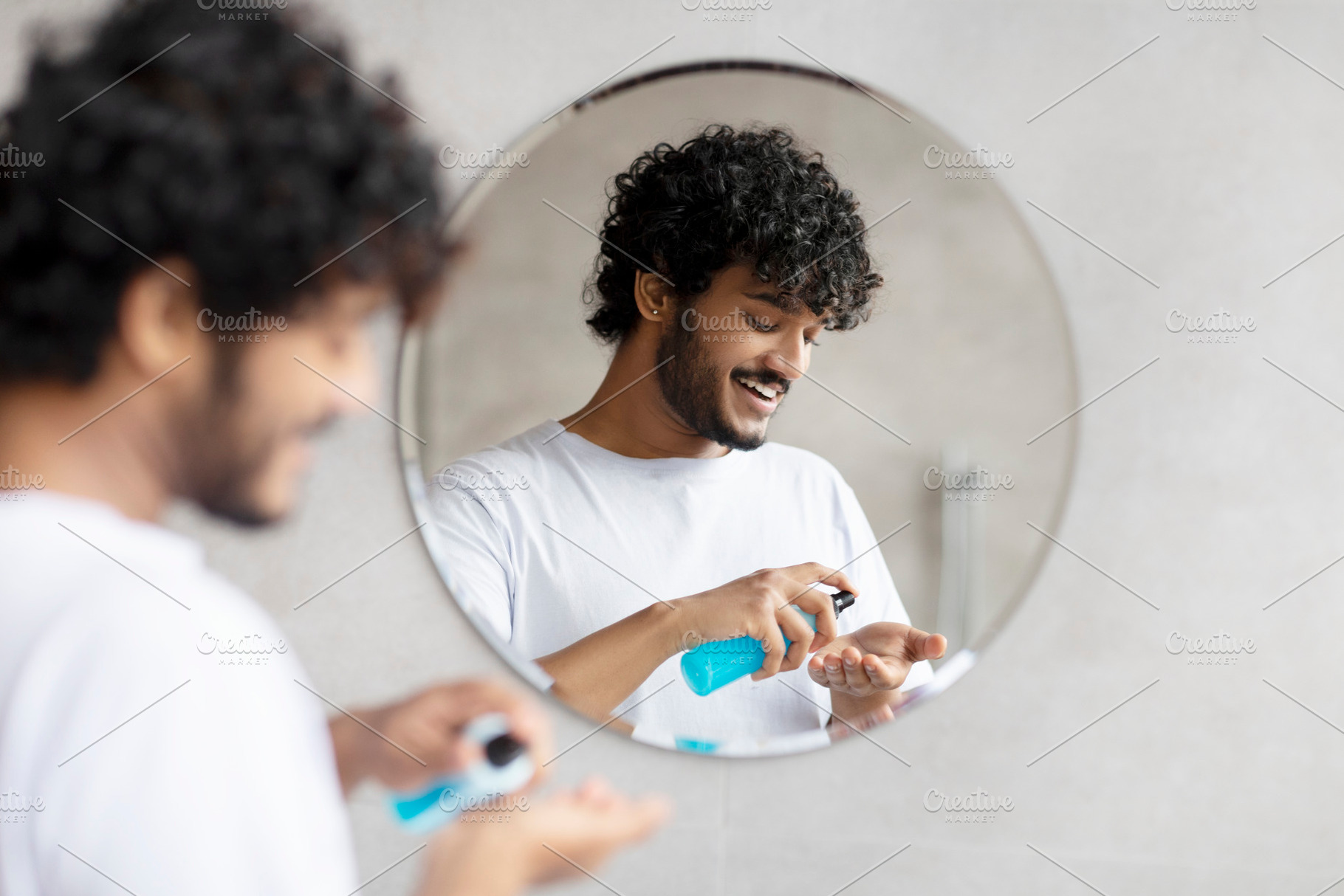 Young indian man applying shaving foam standing in modern bathroom and preparin, a Person Photo by Prostock-Studio