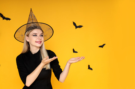 Concept of Halloween, young woman on yellow background, a Person Photo by AtlasStudio PRO