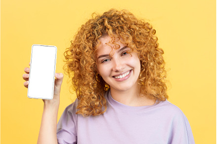 Smiley woman holding a mobile with a, a Person Photo by Iván Moreno STOCK PHOTO