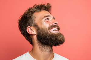 Smiling bearded man looking upwards, a Person Photo by AlyaAnd