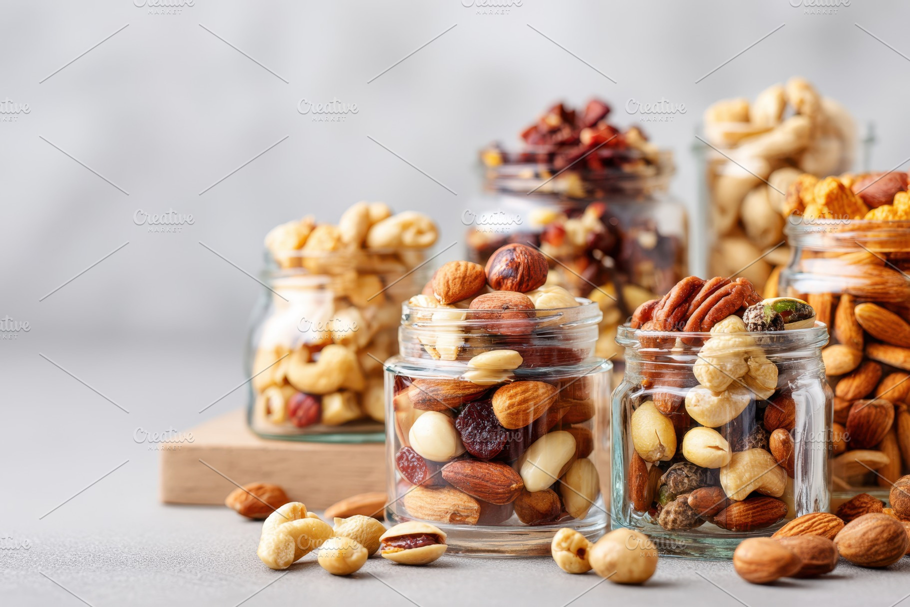 Assorted nuts in glass containers, a Food & Drink Photo by AlyaAnd
