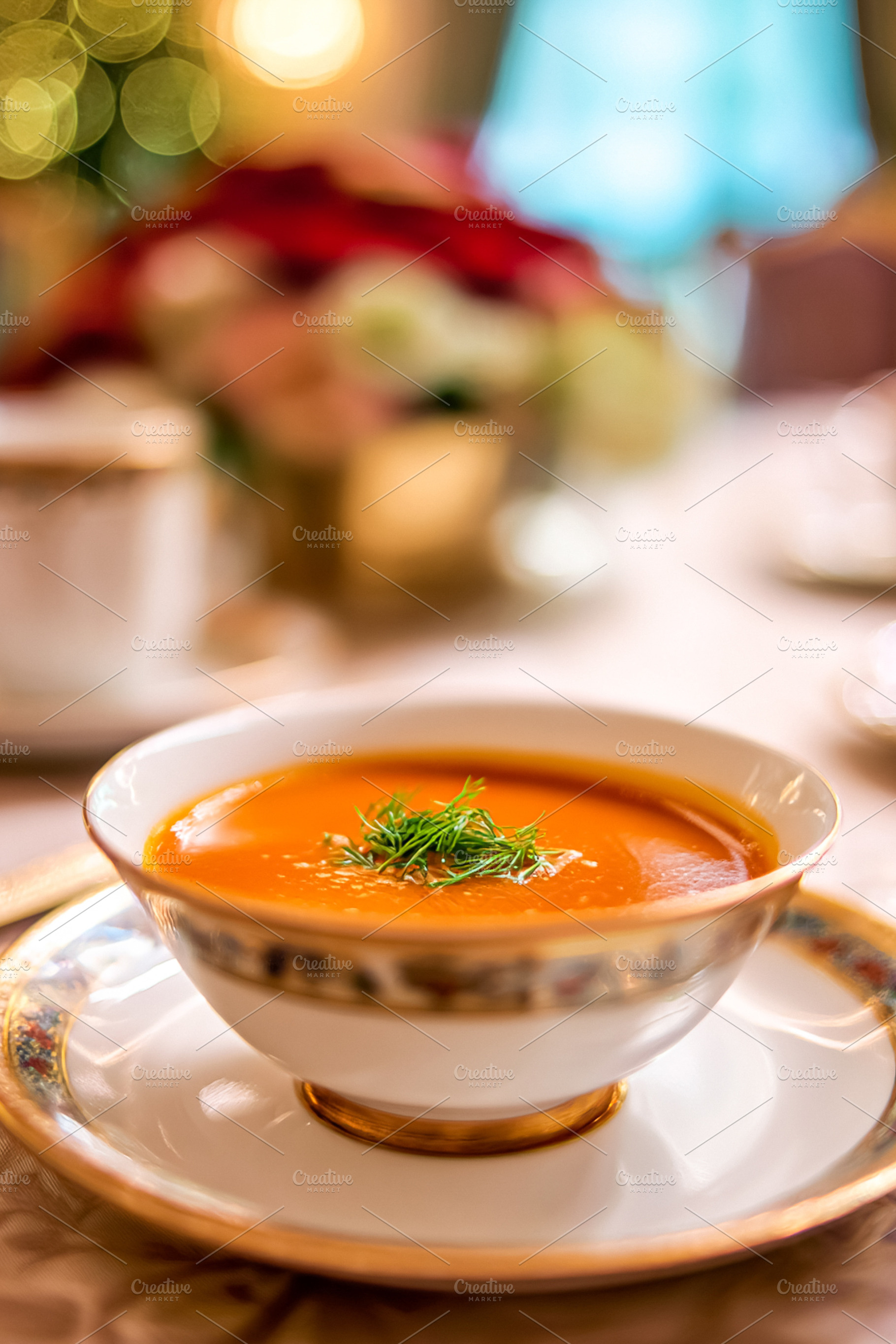 Gourmet butternut squash soup with fresh dill in a luxury hotel, a Photo by Studio ANNA