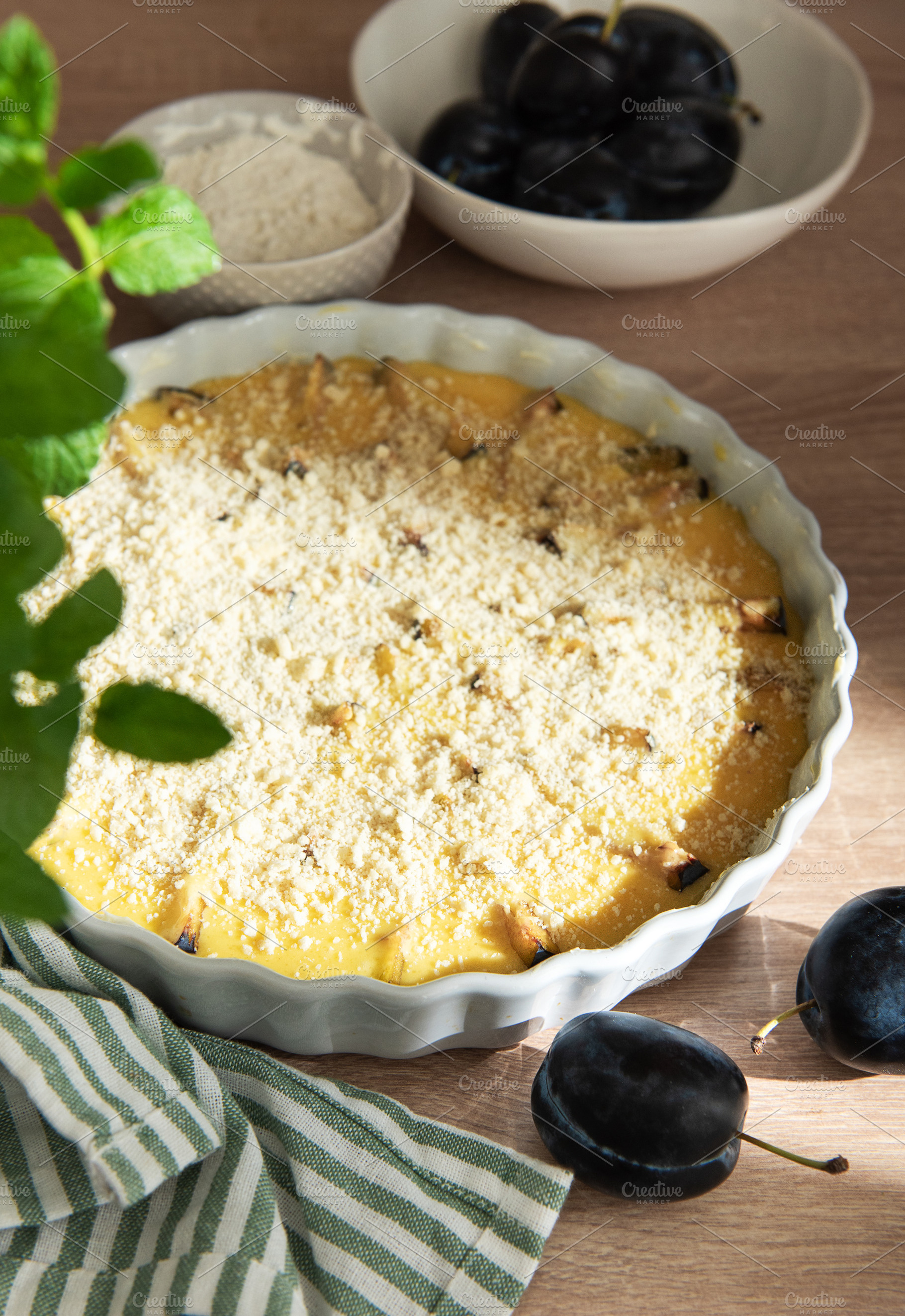 Baking plum crumble with fresh fruit and mint, a Food & Drink Photo by Olena Rudo