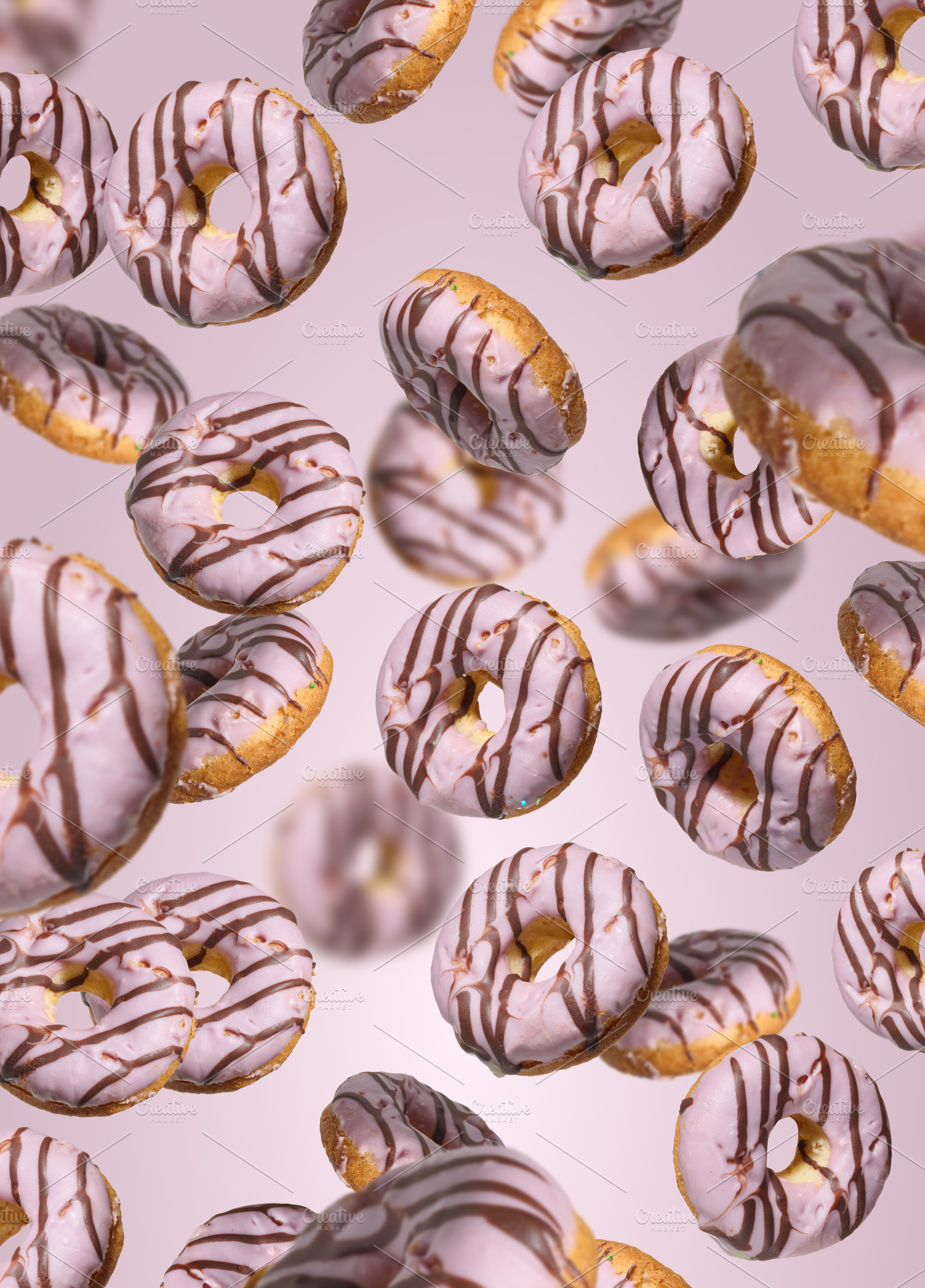 Levitating donuts with pink icing on a bright pink background, a Food & Drink Photo by ndanko