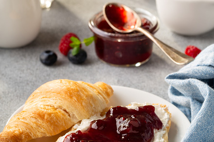 Fresh summer breakfast with croissants and berry jam, a Food & Drink Photo by farwasser