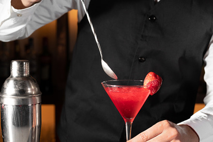 Young barman serving a cocktail at night club., a Person Photo by david.herraez.calzad