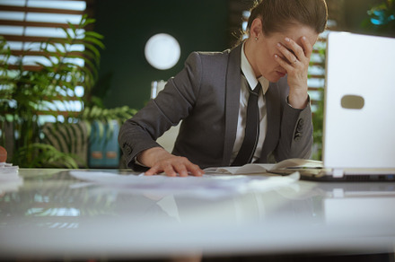 unhappy woman worker in green office throwing documents, a Business Photo by Alliance Images