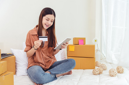 Beauty Asian woman using tablet and credit card. Start up small, a Person Photo by Ministocker