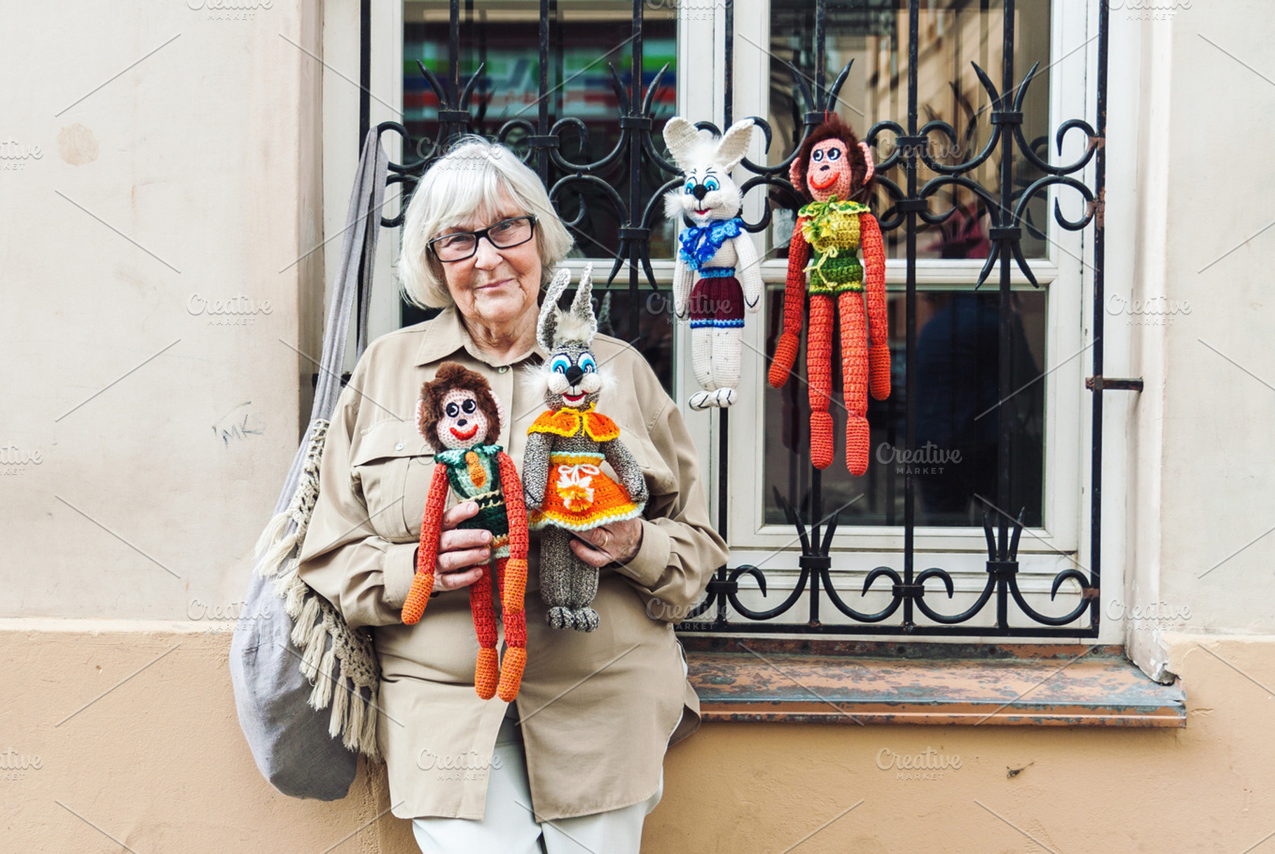 Senior lady selling knitted toys, a Person Photo by BOOCYS