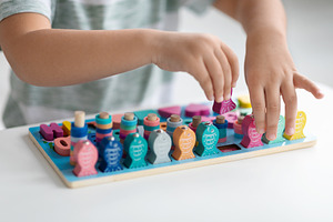Eco-friendly developing toys. Close up shot of little kid playing with wooden f, a Photo by Prostock-Studio