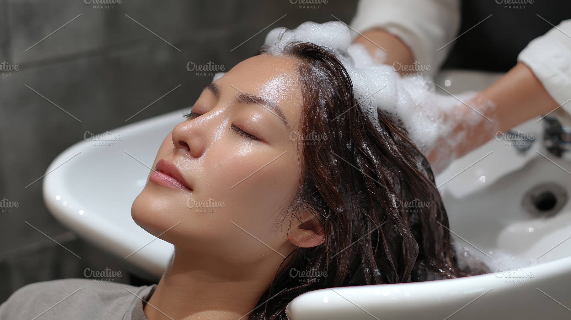 Woman getting hair washed shampoo bu, a Photo by Pixeness Studio