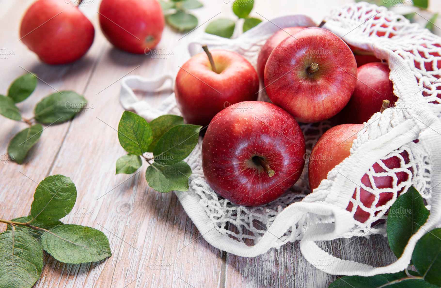 Fresh red apples resting in reusable shopping bag promoting sust, a Food & Drink Photo by Olena Rudo