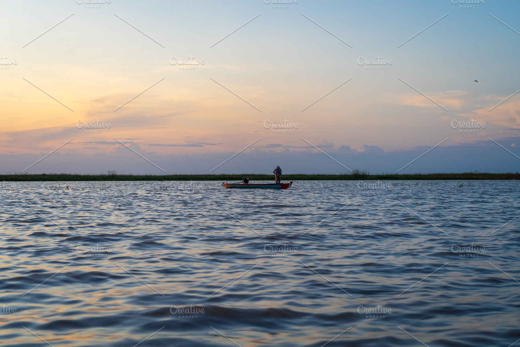 Boat at sunset on Lake Tempe, Sulawesi, Indonesia, a Nature Photo by GoodGoods