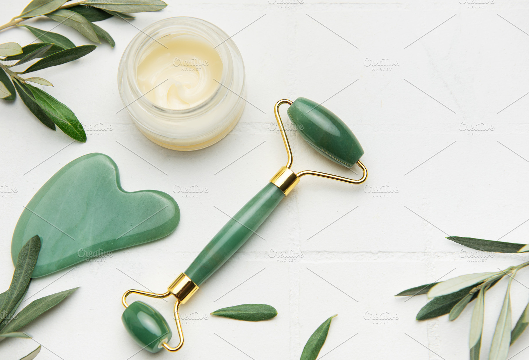 Gua sha stone, face roller and cream promoting skin care and rel, a Health & Medical Photo by Olena Rudo