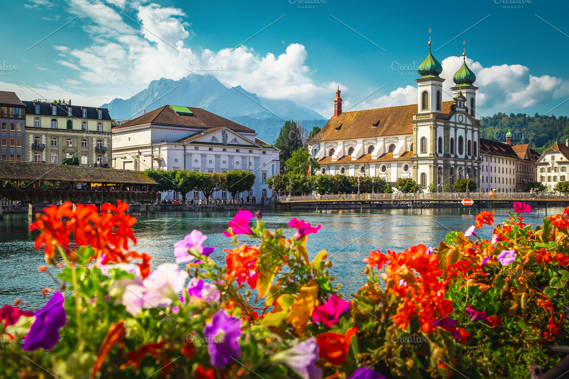 Flowery river side in Lucerne, an Architecture Photo by Alpine Dreams