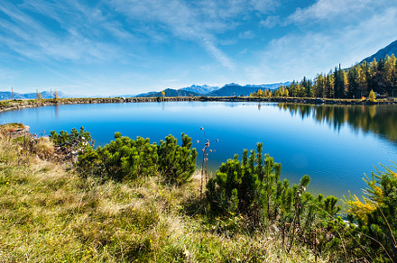 Peaceful autumn Alps mountain lake with clear transparent water, a Nature Photo by YuriyB