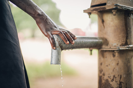 African Child's Hand on Water Spout