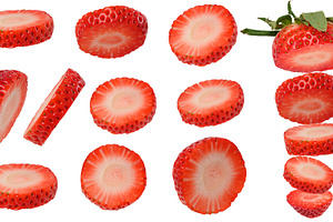 A varied set of thin round slices and cuts of ripe red strawberr, a Photo by ndanko