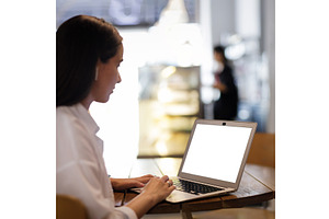 Young pretty woman using laptop in