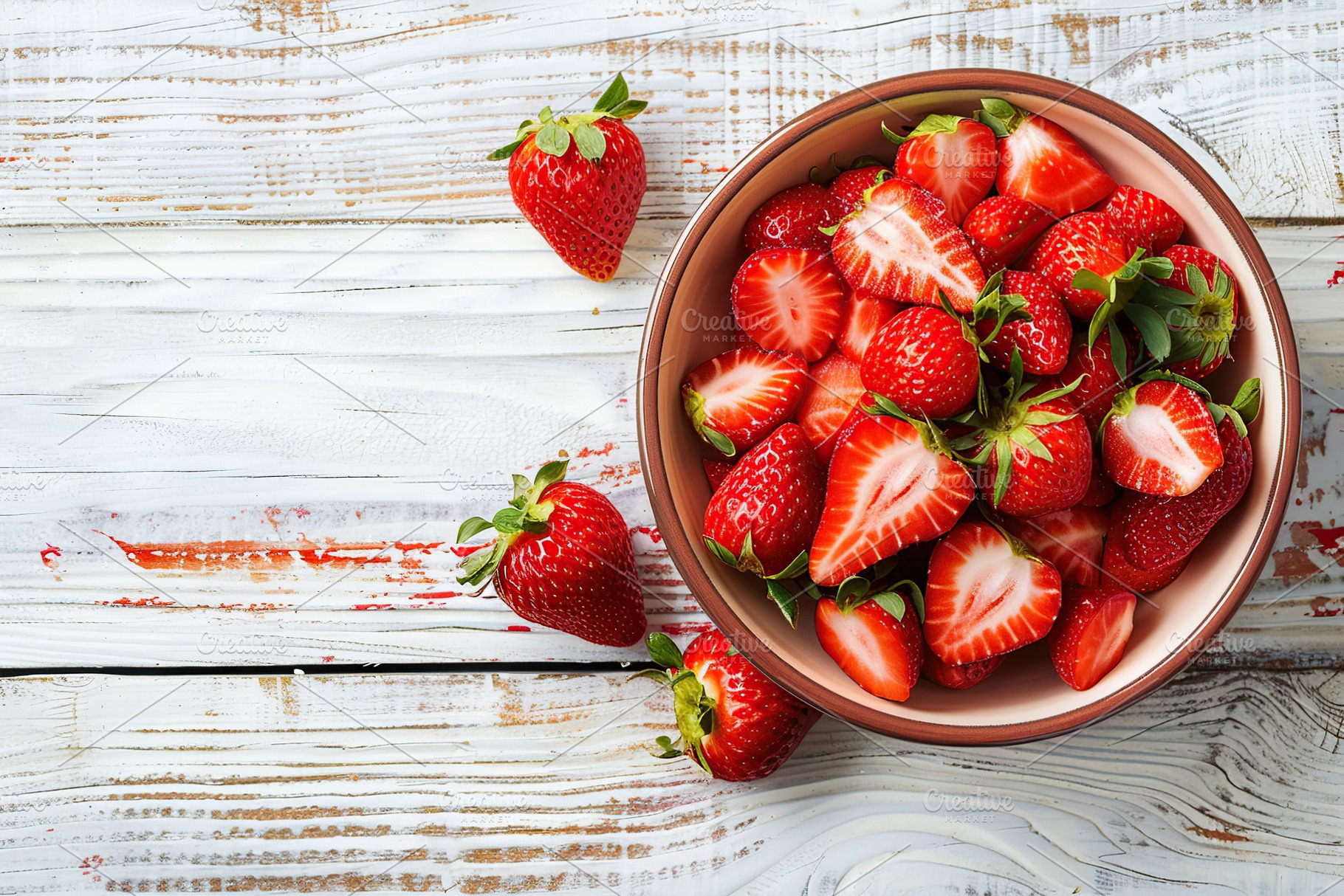 Pieces of strawberries in bowl on wooden table, a Food & Drink Photo by AlyaAnd