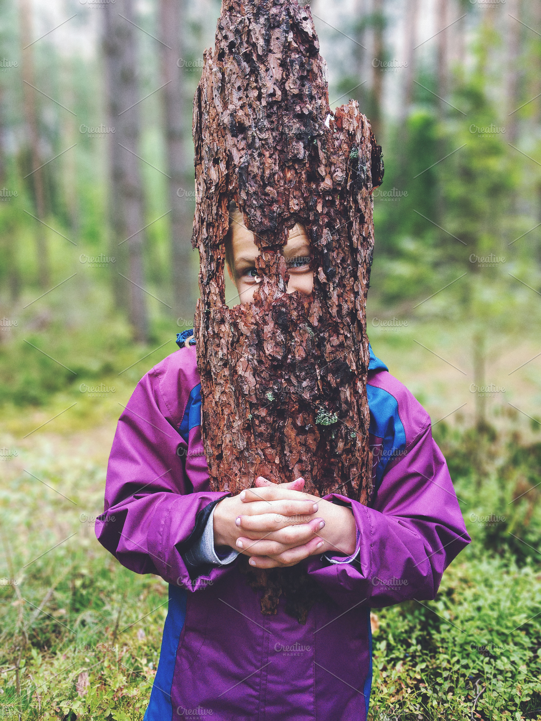 Funny girl with a piece of tree bark, a Person Photo by BOOCYS